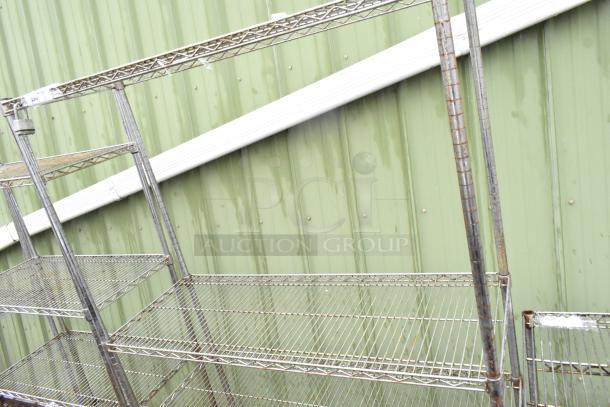Chrome finish 4-tier wire shelving unit, sturdy structure, visible wear. Buyer must dismantle. Consider freight charges.