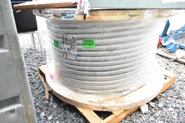 Coil of AL MC-AL cable on wooden spool, marked "Passed Continuity." Packaged and labeled with specifications.