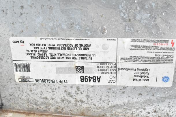 Label on industrial enclosure indicating Type 1 enclosure, Cat No. AB498, by Industrial Solutions, with caution warnings.
