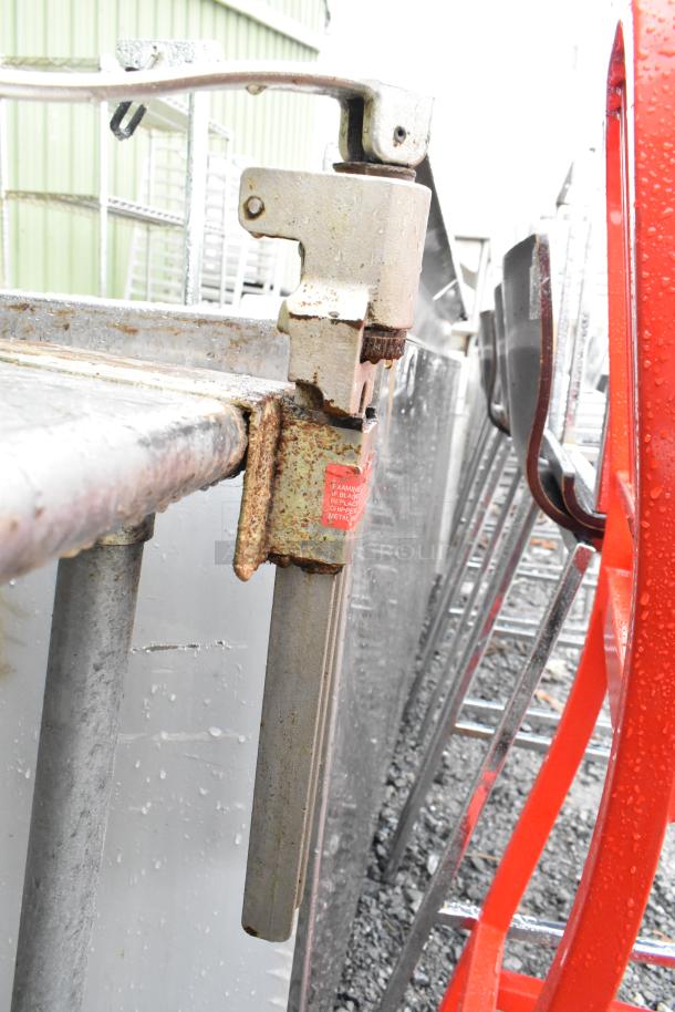 Commercial table with mounted can opener and under shelf, showing signs of rust and wear, includes inspection label.