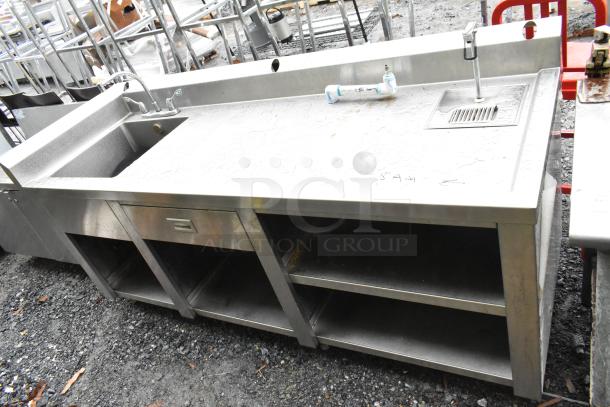 Commercial soda station with water dispenser, sink basin, drawer, and under shelves; stainless steel, used condition.