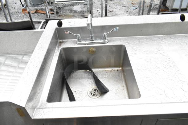 Commercial soda station with water dispenser, stainless steel sink basin, drawer, and under shelves. Used condition.
