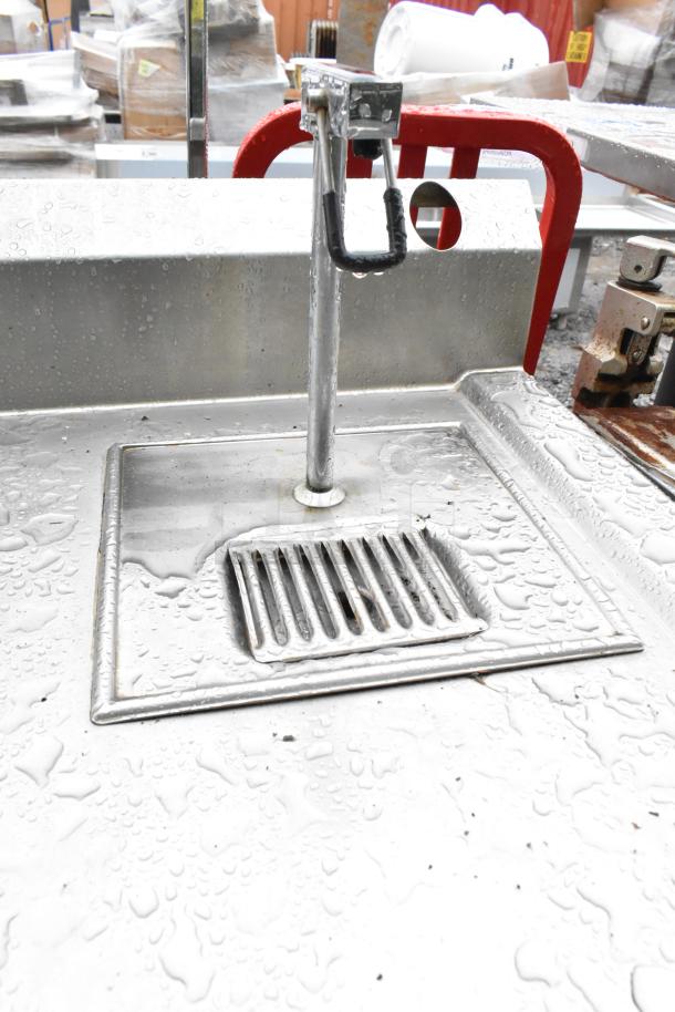 Stainless steel soda station with water dispenser and sink basin, featuring drawer and under shelves, good condition.