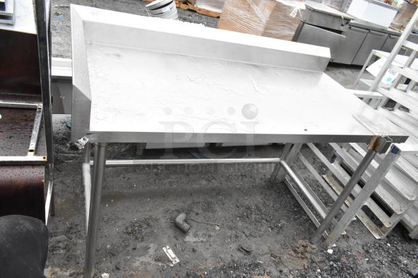 Stainless steel commercial table with can opener mount, used condition, sturdy frame, suitable for kitchen use.
