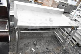 Stainless steel commercial table with can opener mount, used condition, sturdy frame, suitable for kitchen use.