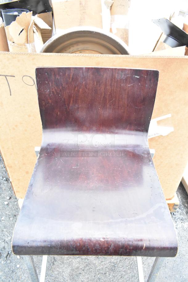Dark wood bar height chair with metal legs, visible wear on the seat. Sold in a lot of 6. Ideal for dining or bar areas.