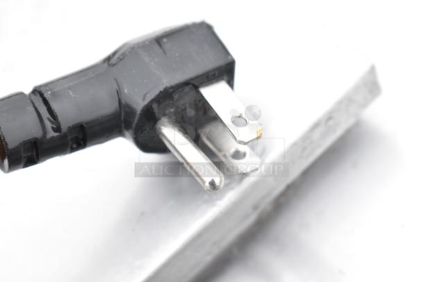 Close-up of a black power plug for the Excellence HFF-8-HC commercial chest freezer, 115 volts, 1 phase.