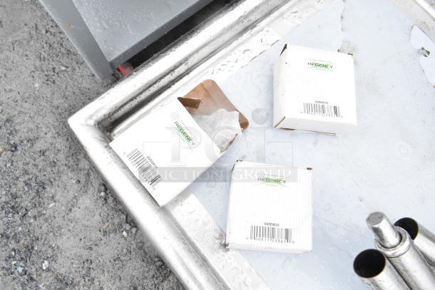 Brand new Regency 600S32323224 commercial 3 bay sink with dual drain boards. Includes visible packaging labeled "600DB35."