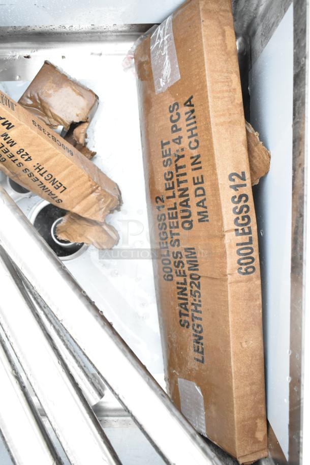 Alt text: Regency 600S32323224 commercial 3 bay sink with dual drain boards, brand new, scratch and dent condition. Includes leg set packaging.