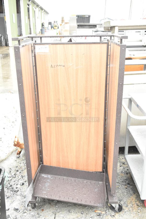 Merchandising rack on casters featuring wood panel sides, metal frame, and adjustable shelving, in used condition.