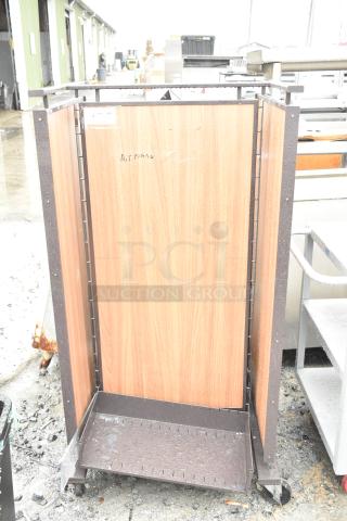 Merchandising rack on casters featuring wood panel sides, metal frame, and adjustable shelving, in used condition.