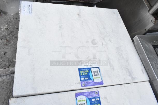 Marble dining table top on metal base, wet surface, tag with QR code and "James River". Auction item, 5 available.