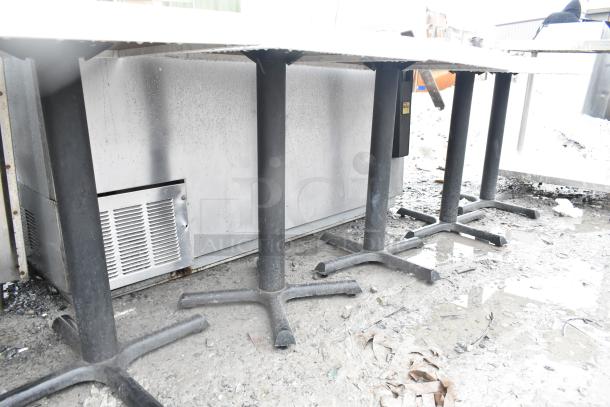 5 dining height tables with sturdy metal bases, showing some wear and outdoor exposure. Ideal for refurbishing.