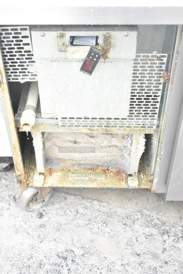 2017 Traulsen TS048HT pizza prep table, showing ventilation and caster wheels. Used condition with surface rust visible.