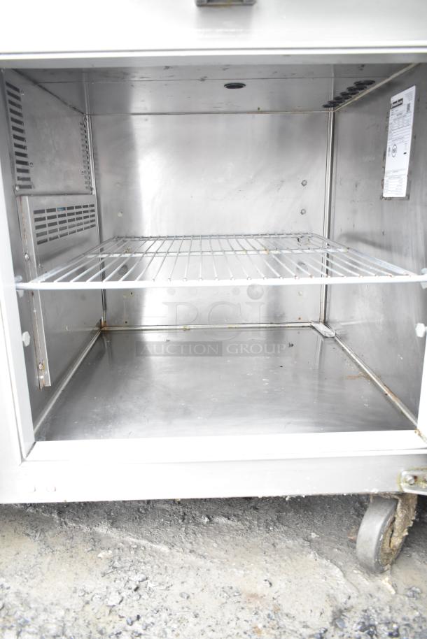 2017 Traulsen TS048HT pizza prep table with commercial casters, 115V, 1 Phase, stainless steel interior, wire shelf, used condition.