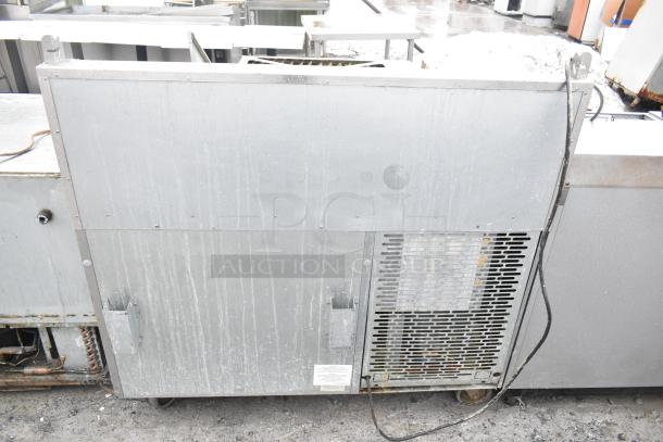 2017 Traulsen TS048HT commercial pizza prep table, visible wear, on casters, 115V, 1 phase. Suitable for restaurant use.