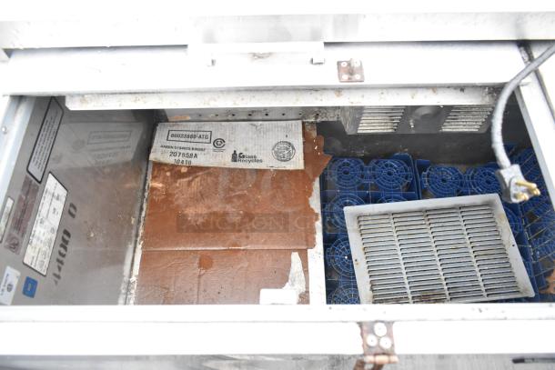 Perlick 7260E-SIL-UL bottle cooler interior with two sliding lids, blue grates, UL marking, and visible casters.