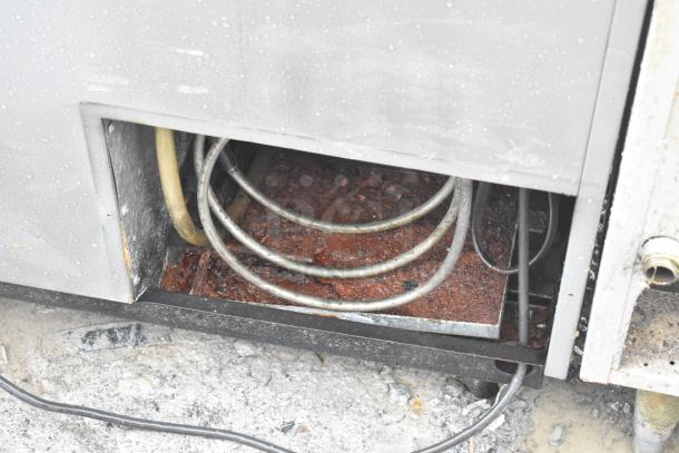 Perlick 7260E-SIL-UL Commercial Back Bar Bottle Cooler with 2 sliding lids, on casters. Visible rust and wear on the interior.