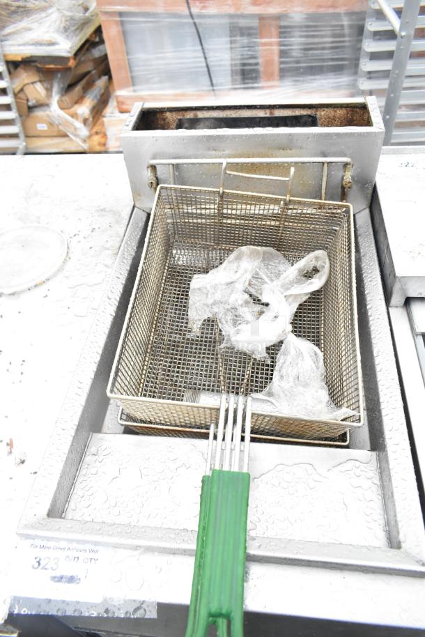 Frymaster GF14SD commercial fryer with metal basket. Natural gas, 105,000 BTU, floor style, includes visible plastic wrap.