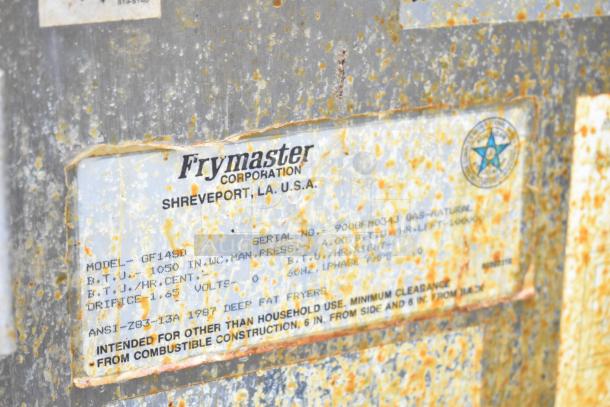 Frymaster GF14SD commercial gas fryer label, showing model, 105,000 BTU, and safety instructions. Used condition with rust.