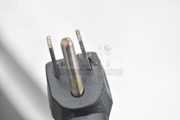 Close-up of a three-prong power plug for the Continental CRA68 Commercial 3 Door Undercounter Cooler.