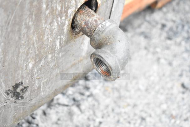 Rusty connection pipe on commercial floor style braising pan, showing signs of wear and corrosion.