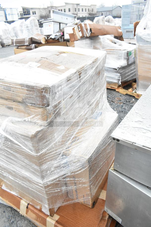 Pallet of wrapped boxes labeled as new scratch and dent items, including Lavex cart, Steelton shelf kit, work table.