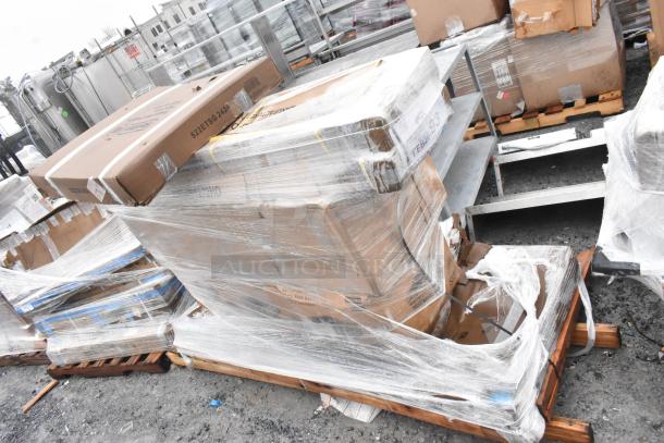 7 brand new scratch and dent items on a pallet, including a traffic door and bi-fold table, wrapped in plastic. Auction lot FEB26-93.