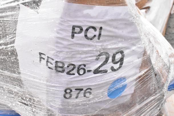 Clear plastic-wrapped pallet labeled "PCI FEB26-29 876," containing 8 scratch and dent items including an equipment stand and pot rack.