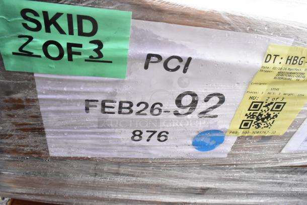 Skid labeled "2 of 3" with shipping details, including "FEB26-92" and QR code. Contains 18 new scratch and dent items.