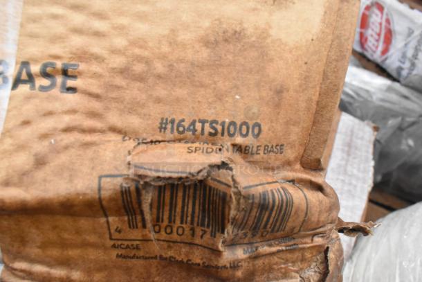 Torn packaging showing label "#164TS1000, Spider Table Base." Barcode partially visible. Condition: scratch and dent.