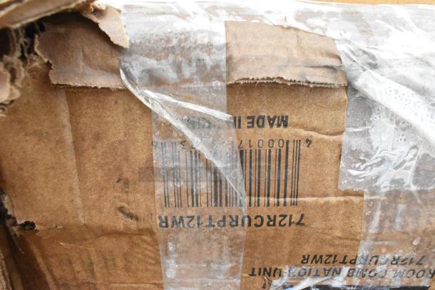 Damaged cardboard box showing barcode and text “Made in” with torn edges, partially covered by transparent tape.