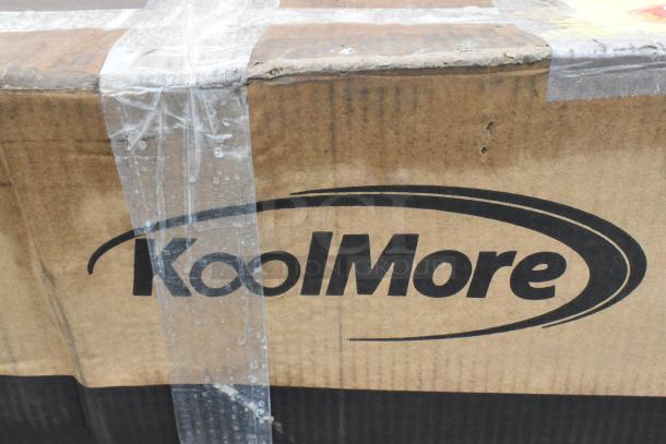 Box labeled "KoolMore," containing a new scratch and dent 48" two-compartment stainless steel commercial sink with drainboard.