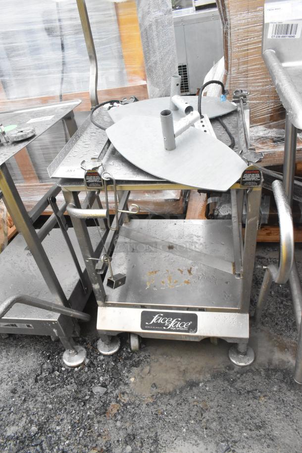 Face to Face commercial meat slicer equipment stand, stainless steel, on wheels, worn surface, "Face to Face" label visible.