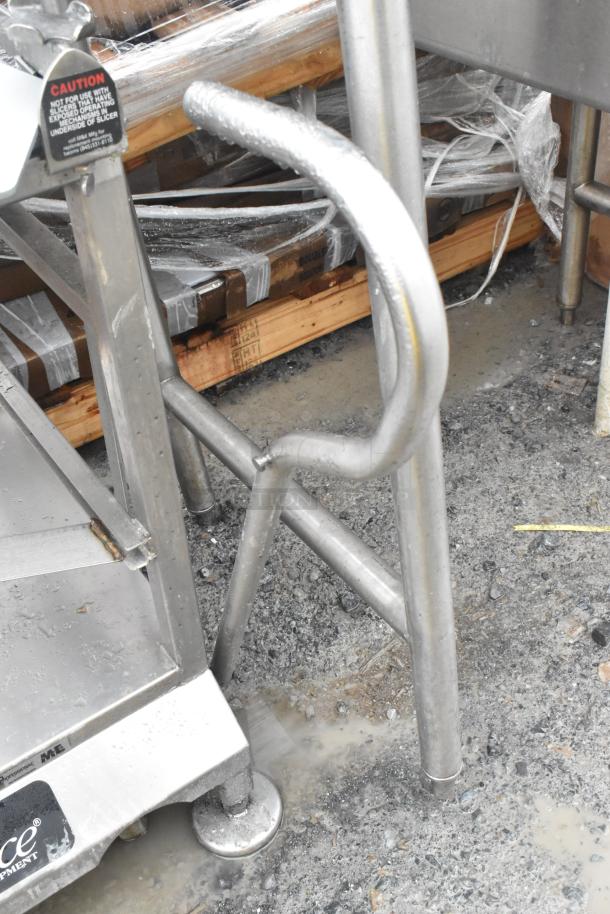 Commercial meat slicer equipment stand, stainless steel, Face to Face brand, sturdy design, used condition, caution label visible.