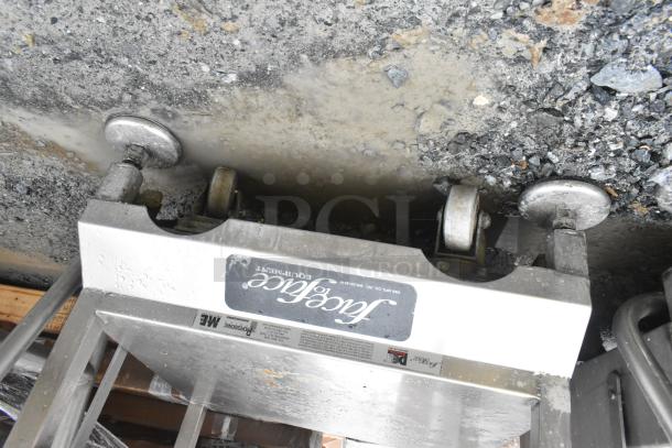 Face to Face Commercial Meat Slicer Equipment Stand with heavy-duty wheels, metal frame, and visible branding label.