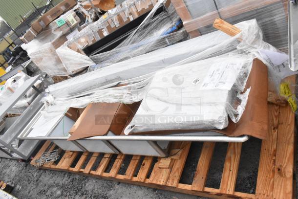 New Winholt WS3T20282D30-2S 3-bay sink with dual drain boards, wrapped and on pallet, minor scratches and dents visible.