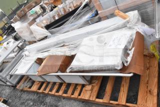 New Winholt WS3T20282D30-2S 3-bay sink with dual drain boards, wrapped and on pallet, minor scratches and dents visible.