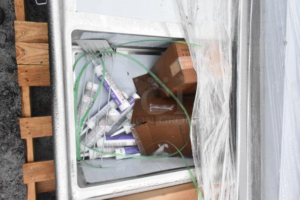 Brand new Winholt WS3T20282D30-2S 3 Bay Sink with dual drain boards, wrapped in plastic, slight scratches visible.