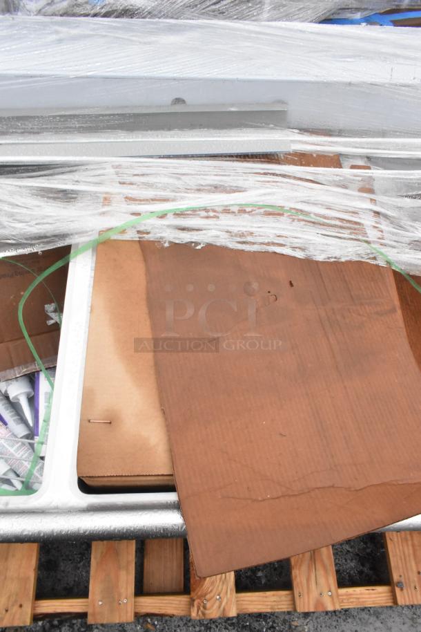 Alt text: Brand new Winholt WS3T20282D30-2S 3 bay sink with dual drain boards, wrapped for shipment. Scratch and dent condition.