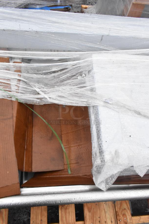 Brand new Winholt WS3T20282D30-2S 3-bay sink with dual drain boards, partially wrapped, visible wood and metal.