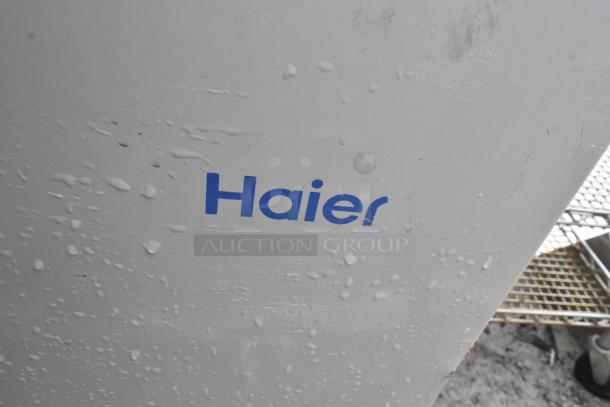 Two Haier HF50CM23NW/HF71CL53NW chest freezers, 115 volts, single phase, shown with visible Haier logo and surface details.