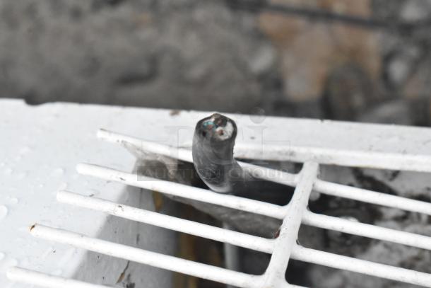 Close-up of a Haier chest freezer's damaged power cord and vent, indicating a need for repair.