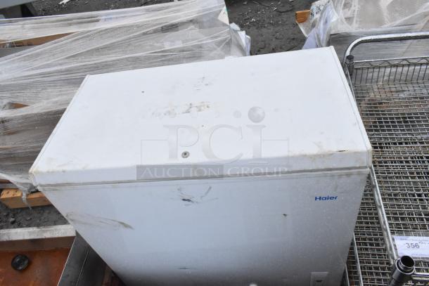 Two Haier chest freezers, models HF50CM23NW and HF71CL53NW, used condition with visible scuffs, 115 volts, 1 phase.