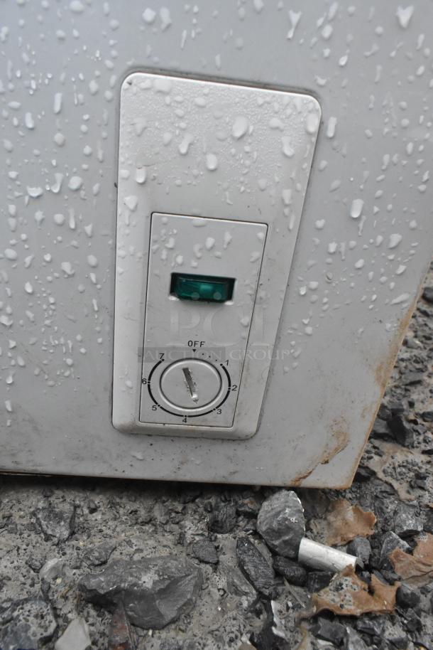 Haier chest freezer control panel with dial and light indicator, showing exterior wear. Model HF50CM23NW/HF71CL53NW. 115 volts.