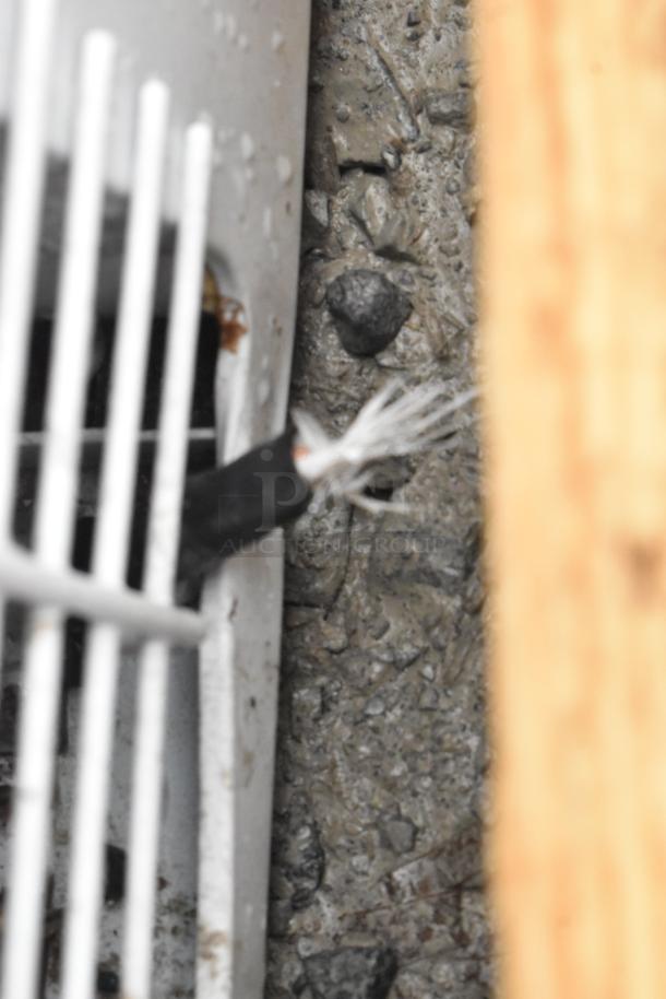 Damaged cord near vent on Haier chest freezer, model HF50CM23NW/HF71CL53NW, 115 volts, 1 phase. Condition requires repair.