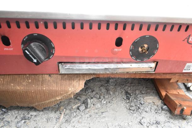 Avantco 177CAG60TG 60" gas griddle, thermostatic controls, 175,000 BTU; visible wear, pilot and temperature knob details.