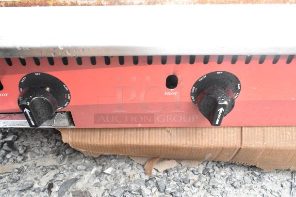 Avantco 177CAG60TG 60" gas griddle with thermostatic controls, 175,000 BTU, showing control knobs and pilot light indicator.