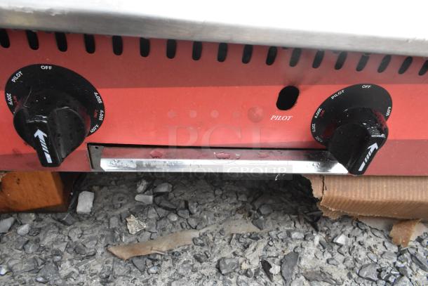 2024 Avantco 177CAG60TG gas griddle controls, thermostatic knobs, pilot indicator, slightly worn condition.