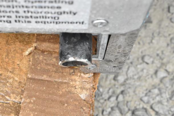 Close-up of the 2024 Avantco 177CAG60TG gas griddle component, showing part of the metal frame and attachment details.